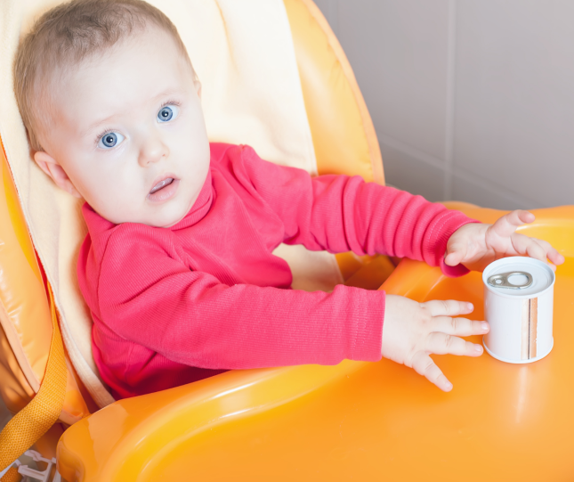 Child in eating chair with food can 