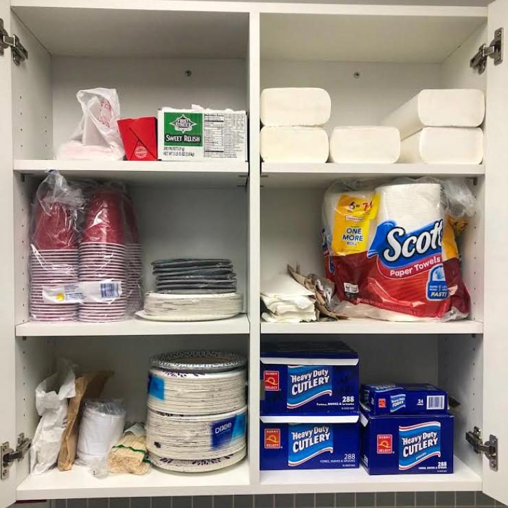 San Carlos Youth Center - Cupboard full of disposable foodware items (plates, utensils, etc)