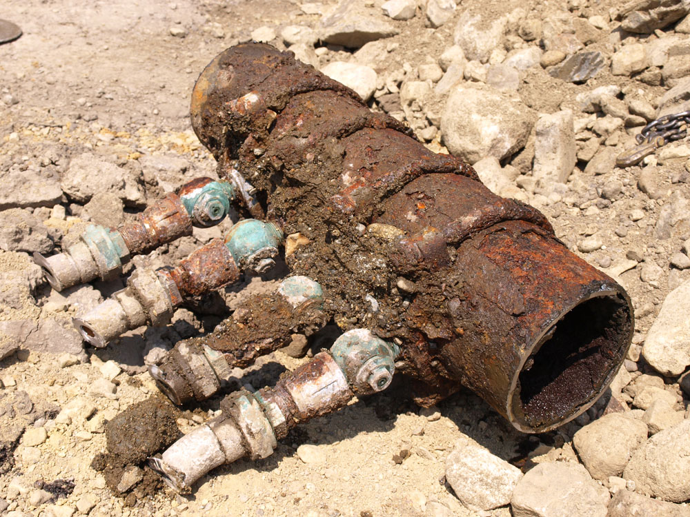 corroded pipe with lead service fittings