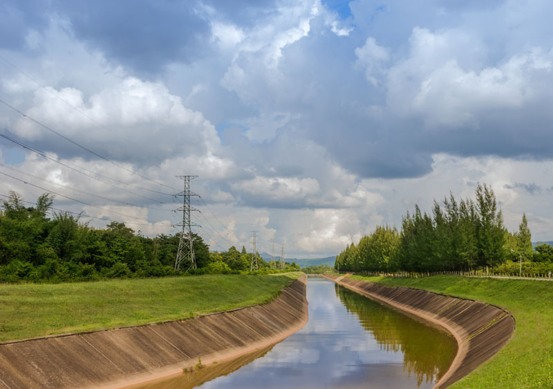 Manmade canal on a sunny day. Photo credit: nayneung1 / Shutterstock