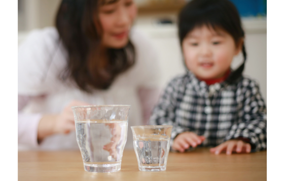 Child and parent with two glasses of water