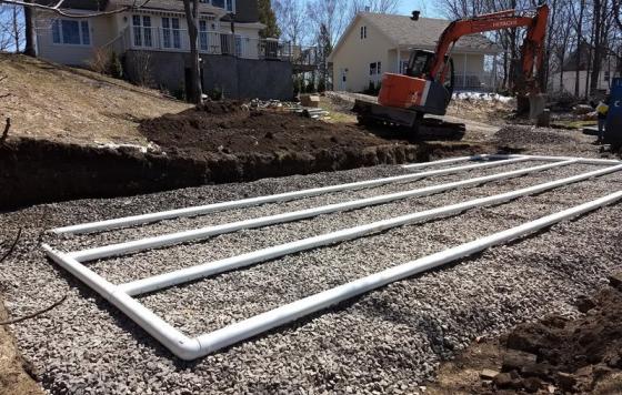 The drain field component of a residential septic system is being put in place. Creative Commons license.